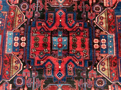Lot 1515 - Persian rug on blue and red ground