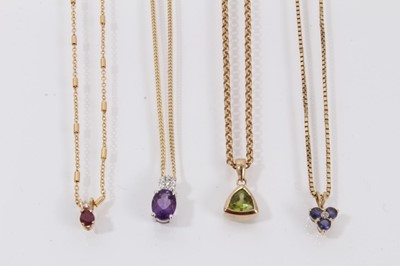 Lot 454 - Four gold and diamond and gem-set pendants on 9ct gold chains