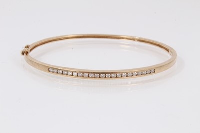 Lot 457 - Diamond bangle with channel set brilliant cut diamonds in 9ct gold setting