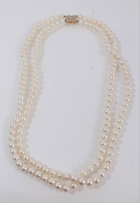 Lot 426 - Cultured pearl two-strand opera length necklace with a 14ct gold and diamond clasp