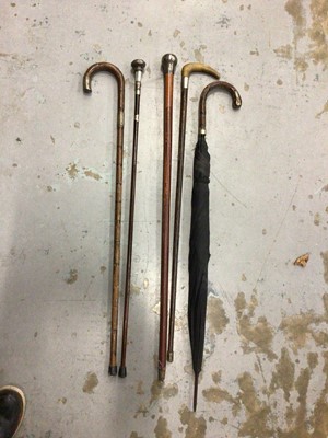 Lot 150 - Four silver mounted walking canes/sticks and an umbrella (5)