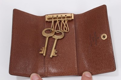 Lot 2089 - Louis Vuitton vanity case with fitted interior, signature monogrammed and brass fittings, together with a Louis Vuitton purse and Louis Vuitton key fob with two keys, label numbered 1029952, lock a...