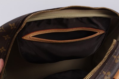 Lot 2090 - Louis Vuitton travel bag with signature monogrammed design and leather handles, together with a Louis Vuitton padlock and key, and. Versace umbrella
