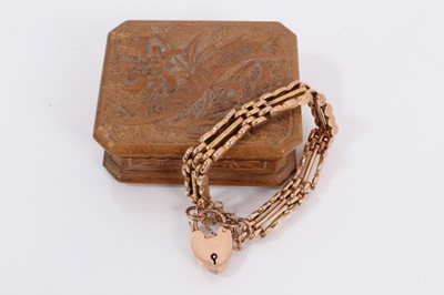 Lot 871 - 9ct rose gold gate bracelet with padlock clasp, within a small carved wood trinket box