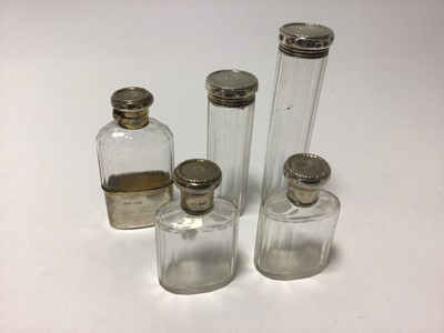 Lot 313 - Set of four silver topped toilet bottles and flask all with Baroness Coronet and monogram