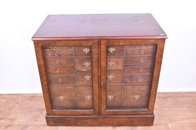 Lot 1335 - Georgian-style walnut collectors cabinet with an arrangement of drawers enclosed by glazed doors