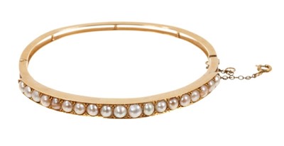 Lot 467 - Late Victorian gold and pearl hinged bangle, Victorian gold seed pearl floral spray brooch and a ring (3)
