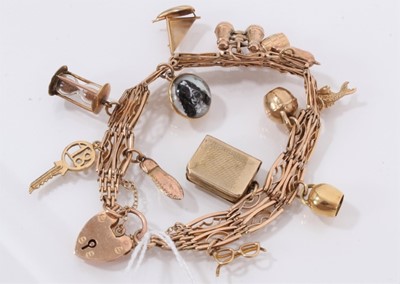 Lot 836 - 9ct gold charm bracelet with thirteen gold and yellow metal novelty charms