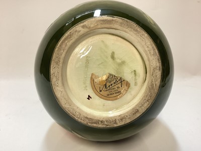 Lot 1250 - Moorcroft pottery vase decorated in the Hibiscus pattern on green ground, impressed marks to base, and original paper label - Potters To The Late Queen Mary, 21.5cm high