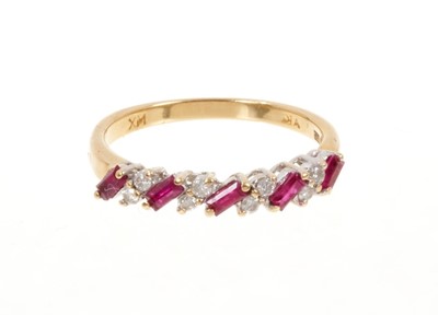 Lot 447 - Ruby and diamond eternity ring with a half hoop of rectangular step cut rubies interspaced by pair of brilliant cut diamonds in 18ct gold setting.