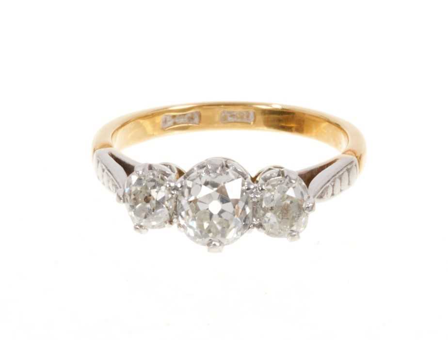 Lot 427 - Diamond three stone ring with three old cut cushion shape diamonds in platinum claw setting on 18ct gold shank. Estimated total diamond weight approximately 1.68cts