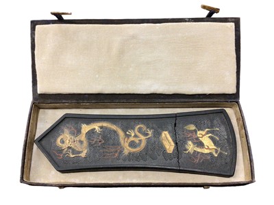 Lot 11 - Chinese carved inkstone of lozenge form, carved with mythical beasts, 28cm long, in case