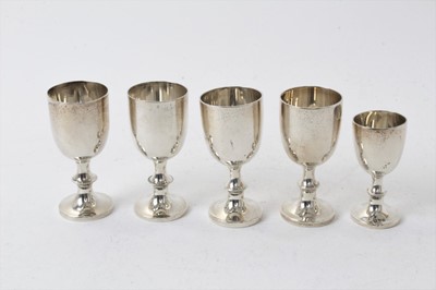 Lot 211 - Four Edwardian silver egg cups with beaded collars