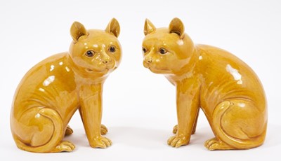 Lot 69 - Pair of Chinese yellow glazed models of seated cats, probably Republic period, 17cm high