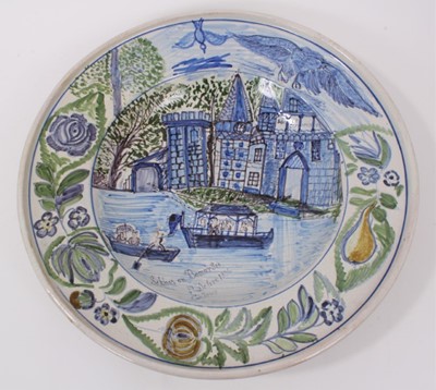 Lot 72 - An unusual tin glazed earthenware dish, painted with a castle and inscribed 'Schloss Bonnarsee (?) in jahre 1805, G. Krank (?)', fruit, flowers and birds around the outside, 36cm diameter