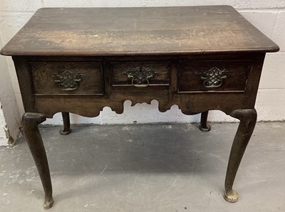 Lot 1306 - Mid 18th century oak lowboy, having three drawers over fretwork frieze, raised on cabriole legs and pad feet, 91cm wide x 57cm deep x 73cm high