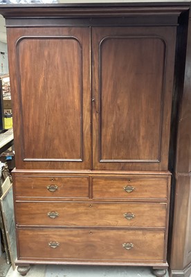 Lot 1345 - Victorian mahogany linen press, with moulded cornice and fitted interior of slides enclosed by pair of doors, the base with two short over two long graduated drawers on bun feet, 128cm wide x 56cm...