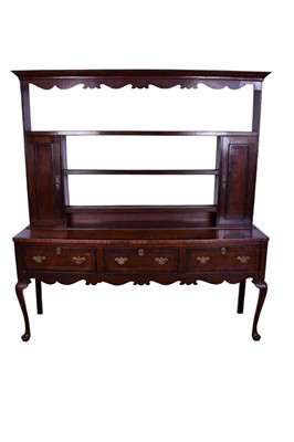 Lot 1369 - Large mid-18th century oak and fruitwood cross banded high dresser, the boarded plate rack with twin cupboards, the base with three frieze drawers on slender cabriole legs and pad feet, 183cm wide...