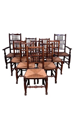 Lot 1370 - Near set of ten 19th century ash and elm spindle back chairs, each with rush seat, raised on turned legs and hoof feet