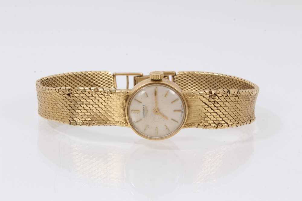 Lot 612 - 18ct gold Longines wristwatch with mechanical movement in circular gold case on integral gold Milanese bracelet, case 16mm diameter.