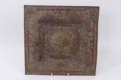 Lot 781 - Tibetan copper and brass tray, of dished form, decorated with mythical masks and arabesques, 31cm wide