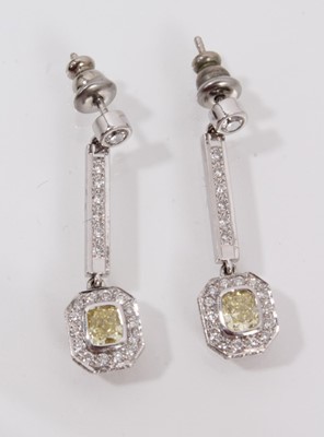 Lot 460 - Pair of yellow diamond and white diamond pendant earrings, each with a rectangular cushion cut yellow diamond measuring approximately 4.3mm x 3.6mm x 2.4mm surrounded by brilliant cut diamonds susp...