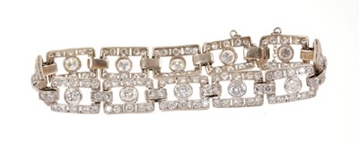 Lot 418 - Art Deco style diamond bracelet articulated rectangular openwork panels, each with a round brilliant cut diamond within a diamond border, in white gold setting. Estimated total diamond weight appro...