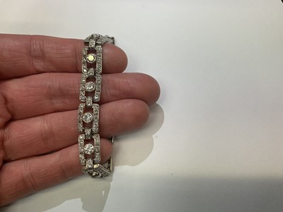 Lot 418 - Art Deco style diamond bracelet articulated rectangular openwork panels, each with a round brilliant cut diamond within a diamond border, in white gold setting. Estimated total diamond weight appro...