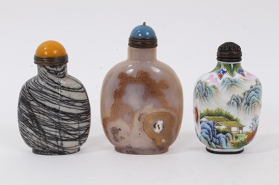 Lot 803 - Chinese carved agate snuff bottle, of globular form with lapis type cap, 9cm high, together with a banded agate snuff bottle and painted porcelain snuff bottle. (3)