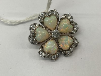 Lot 476 - Late Victorian opal and diamond flower brooch in the form of a pansy, with five heart shaped opal petals and old cut diamonds in silver and gold setting, 24mm.