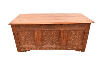 Lot 1421 - Large 17th century carved oak coffer, with plank lid and triple panel front raised on stiles with carved brackets, 151cm wide x 67cm deep x 70cm high