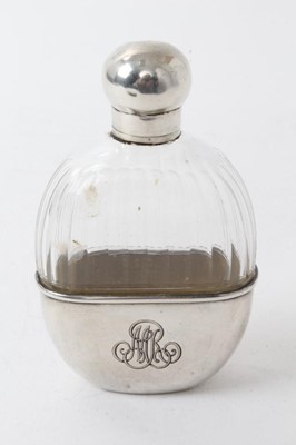 Lot 320 - Early 20th century French silver scent/spirit flask with cut glass body, screw fitting cap and glass stopper, the removable cup with engraved initials and marked with French control marks. 10.5cm...