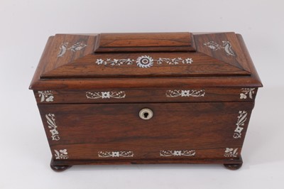 Lot 792 - William IV rosewood sarcophagus form tea caddy with twin ring handles and inlaid mother of pearl decoration, raised on four bun feet, the interior with two hinged cannisters and a cut glass sugar b...