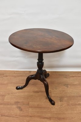 Lot 1498 - Mid 18th century mahogany tripod table, with well figured solid circular tilt top on vase shaped column and tripod cabriole legs, with pointed pad feet, 63cm diameter