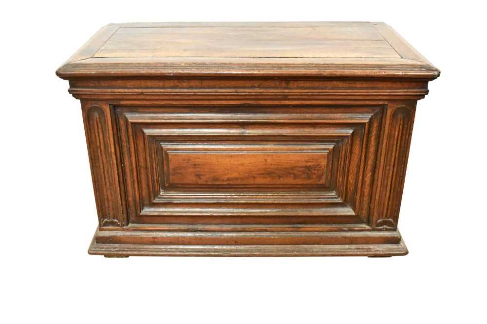 Lot 1466 - 17th century Continental oak cassone, of small size, with hinged lid and interior candle box, panelled front flanked by iron carrying handles, on stiles