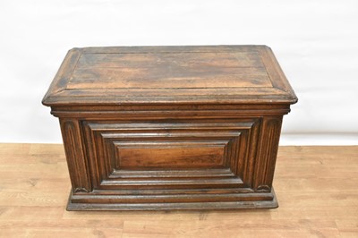 Lot 1466 - 17th century Continental oak cassone, of small size, with hinged lid and interior candle box, panelled front flanked by iron carrying handles, on stiles