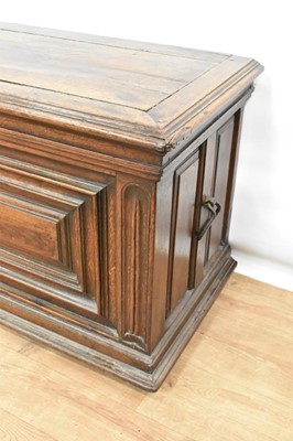 Lot 1466 - 17th century Continental oak cassone, of small size, with hinged lid and interior candle box, panelled front flanked by iron carrying handles, on stiles