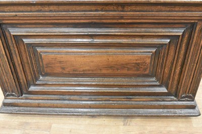 Lot 1466 - 17th century Continental oak cassone, of small size, with hinged lid and interior candle box, panelled front flanked by iron carrying handles, on stiles