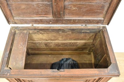 Lot 1466 - 17th century Continental oak cassone, of small size, with hinged lid and interior candle box, panelled front flanked by iron carrying handles, on stiles