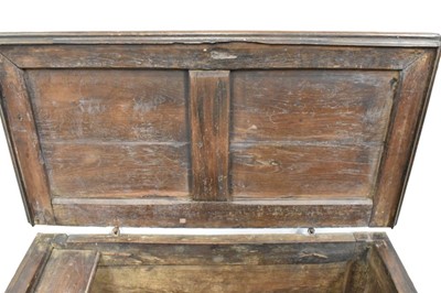 Lot 1466 - 17th century Continental oak cassone, of small size, with hinged lid and interior candle box, panelled front flanked by iron carrying handles, on stiles