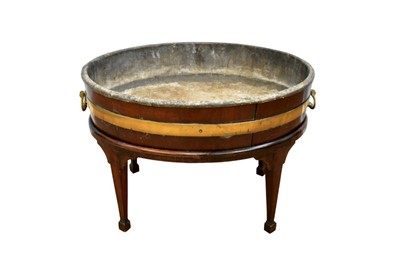 Lot 1477 - Large George III mahogany and brass bound oval jardinière on later stand, the lead lined jardiniere with flanking brass drop carrying handles, 78cm wide on stand with splayed supports