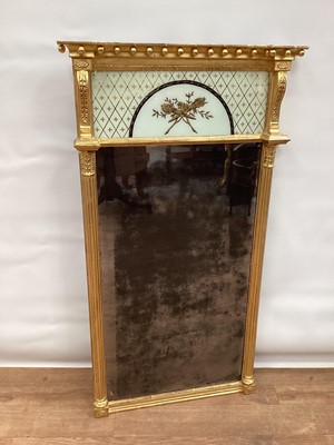 Lot 1484 - Regency gilt gesso pier mirror, with ball mounted concave cornice and verre églomisé tablet oval original mirrored plate flanked by fluted cut columns, 120 x 63cm