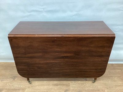 Lot 1295 - Early 19th century mahogany drop leaf dining table, rounded rectangular hinged top with reeded edge, on turned legs amd castors, 152cm x 106cm x 73cm high
