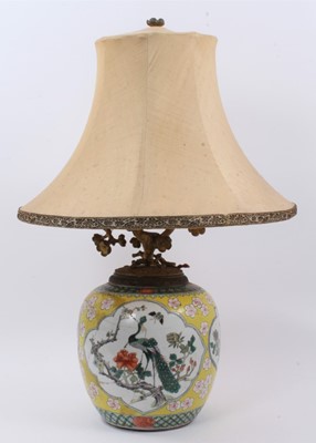 Lot 130 - Chinese famille jaune porcelain jar, decorated with panels containing flowers, insects and a peacock, on a yellow ground with prunus blossom, Qianlong seal mark to base but 19th century, converted...