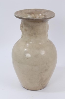 Lot 132 - Antique Chinese cream glazed stoneware vase, Qing or earlier, of baluster form with moulded mask and ring decoration, 31.5cm high