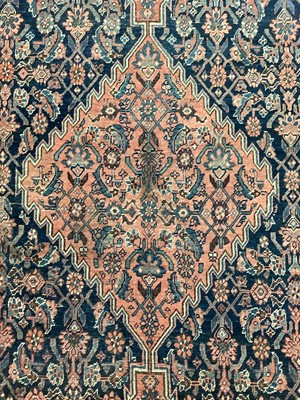 Lot 1506 - West Persian rug, with central diamond shaped medallion and knot work spandrels on midnight blue ground, in foliate borders, 206 x 148cm