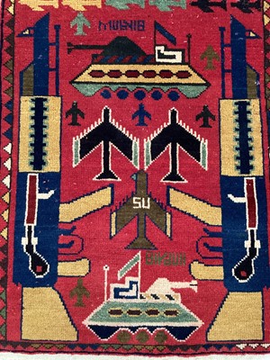 Lot 1522 - Two 1970s Afghan political rugs with war motifs, approximately 90cm x 65cm.