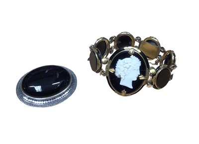 Lot 31 - Victorian black glass cameo bracelet in yellow metal setting together with a black onyx and silver brooch (2)
