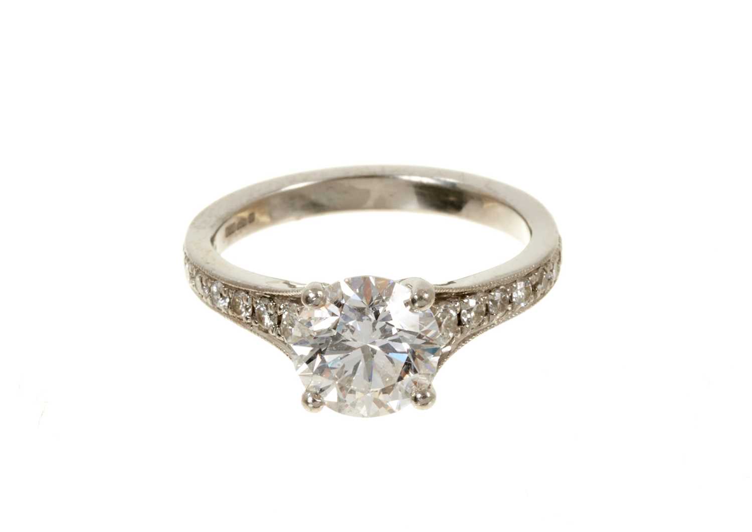 Lot 636 - Diamond single stone ring with a round brilliant cut diamond weighing 1.51cts in platinum four claw setting with graduated diamond set shoulders on platinum shank. Accompanied by a Diamond Report b...
