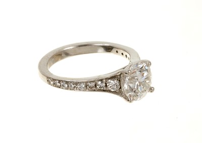Lot 636 - Diamond single stone ring with a round brilliant cut diamond weighing 1.51cts in platinum four claw setting with graduated diamond set shoulders on platinum shank. Accompanied by a Diamond Report b...